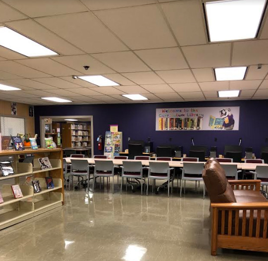 photo of table and shelves of books