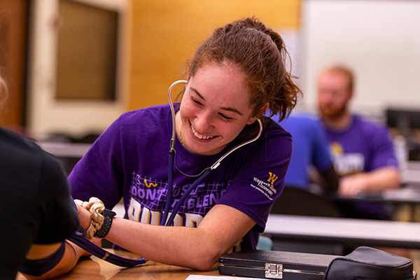 student testing blood pressure