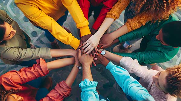 people holding hands in a circle