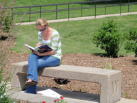 Woman reading a book at Cardinal Court